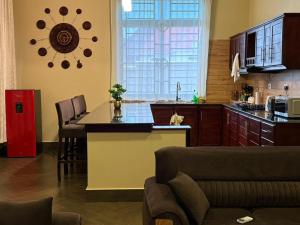 a kitchen with a large window and a table in a room at Nadyapartment in Dodoma