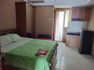 a bedroom with a bed with a tray on it at Japlen Room in Pondokcabe Hilir