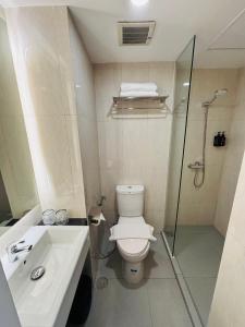 a bathroom with a toilet and a shower and a sink at Bogorienze City Resort in Pamoyanan +31 photos