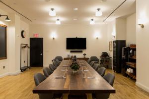a large conference room with a long table and chairs at Ace Hotel New York in New York