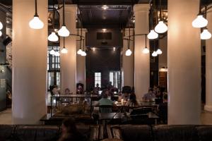 a group of people sitting at tables in a restaurant at Ace Hotel New York in New York