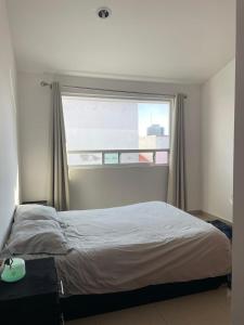a bedroom with a bed and a window with a view at Alma Xoloitzcuintle in Hércules