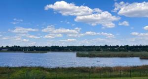 a large body of water with clouds in the sky at Flamingo on Korsman in Benoni