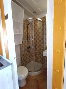a bathroom with a shower with a toilet and a sink at Cencibel - Harbor's Light in Villajoyosa
