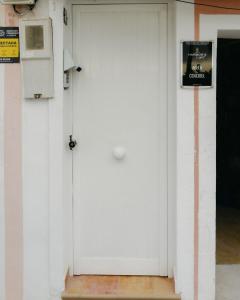 a white door with a sign on a wall at Cencibel - Harbor's Light in Villajoyosa