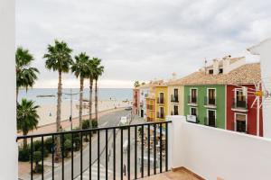 a balcony with a view of the beach and buildings at Cencibel - Harbor's Light in Villajoyosa