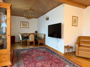 a living room with a table and a tv at Haus Ingrid in Mauerbach
