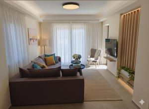 a living room with a couch and a table at Agnanti Houses in Mythimna