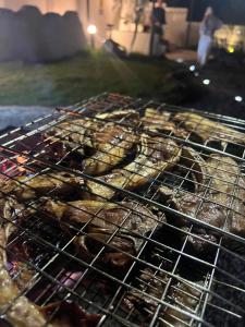 a bunch of donuts are cooking on a grill at zahr albun villa in Al Raka