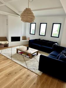 a living room with a couch and a coffee table at Villa Haizea proche Bidart in Ahetze