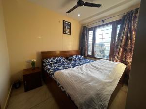 a bedroom with a bed with a window and a bed sidx sidx sidx at Uttarayan The Homestay in Almora