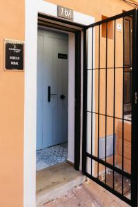 an entrance to a building with a blue door at Godello - Harbor's Light in Villajoyosa