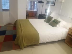 a bedroom with a large white bed in a room at The office 2020 in Tres Cantos