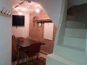 a dining room with a table and a brick wall at The office 2020 in Tres Cantos