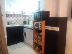 a kitchen with a microwave on top of a stove at The office 2020 in Tres Cantos