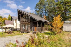 a large house with a black roof at Hakuba Powder Cottage in Hakuba
