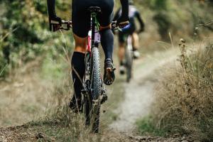two people riding bikes down a dirt trail at Sam's Cottage on Hennessey in Moe