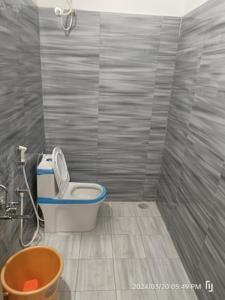 a bathroom with a toilet and a bucket at BNS Village Resort in Kolli Hills
