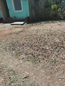 a pile of leaves on the ground in front of a house at Samarth hotel in Robertsonpet