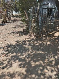 a telephone booth sitting in the middle of a dirt road at Samarth hotel in Robertsonpet