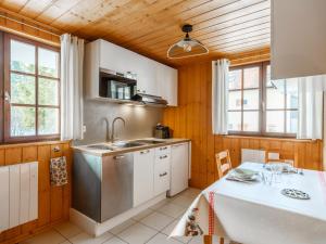 a kitchen with a sink and a table with chairs at Le Diable Bleu in Lamoura