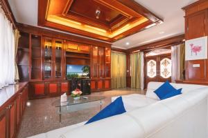 a living room with a white couch and a glass table at The Phuket Pool Villa in Phuket +290 photos