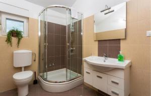 a bathroom with a shower and a toilet and a sink at Villa Sbay in Omišalj +59 photos