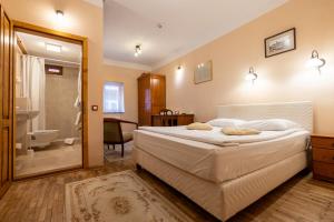 a bedroom with a large bed and a bathroom at Casa Wagner in Braşov +113 photos