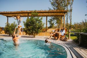 a group of people in a swimming pool at AfriCamps at Oakhurst in Wilderness