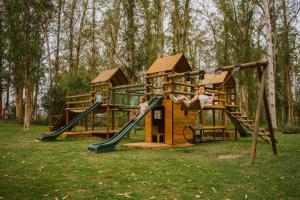 two children playing on a playground in a park at AfriCamps at Oakhurst in Wilderness