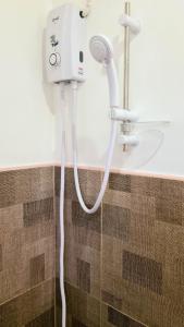 a shower with a hair dryer in a bathroom at Coconut El Nido in El Nido