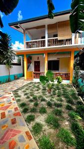 a house with a yard in front of it at Coconut El Nido in El Nido