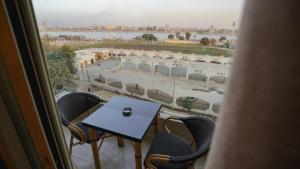 a table and chairs in a room with a view at The View Luxor hotel in Luxor