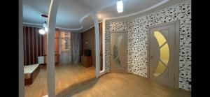 a room with a hallway with two doors and a television at Ciocana in Chişinău +2 photos