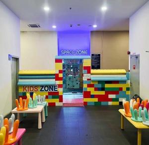 a lego store with tables and chairs in a room at Wafiq Studio in Kota Bharu
