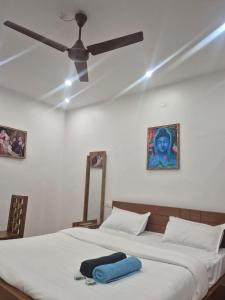 a bedroom with two beds with a ceiling fan at EVA AYURVEDIC beach hotel in Varkala