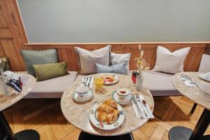 a room with two tables and a couch with food on it at Stylish Duplex Apartment in Morges