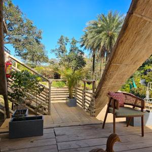a view of a patio with a chair and trees at Aaryavan, A boutique resort in Mount Ābu
