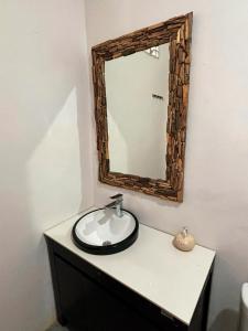 a bathroom with a sink and a mirror on the wall at Winners surfing bali resort in Airsatang +11 photos