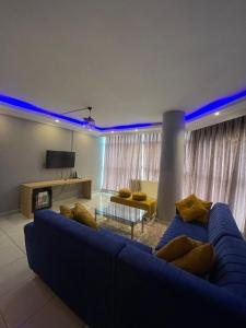 a living room with a couch and a blue light at Rosse Hotel in Esenyurt