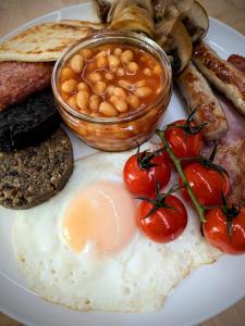 a plate of breakfast food with eggs beans and toast at Tullochard House B&B in Dunvegan