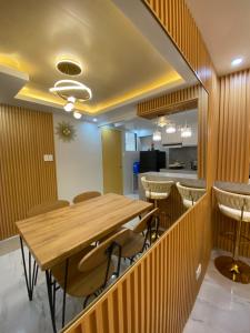 a dining room with a wooden table and chairs at Urban Haven- Naga City in Naga +4 photos