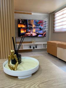 a living room with a coffee table and a tv at Urban Haven- Naga City in Naga