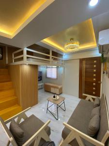 a living room with a couch and a table at Urban Haven- Naga City in Naga