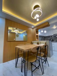 a dining room with a wooden table and chairs at Urban Haven- Naga City in Naga