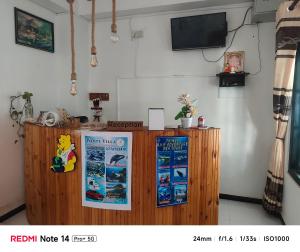 a counter with two posters on it in a room at White Villa Hotel in Trincomalee