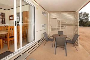 a small dining room with a table and chairs at BIG4 Opal Holiday Park in Lightning Ridge +53 photos