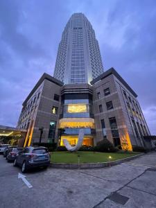 a large building with a large whale sculpture in a parking lot at Ramada Plaza Pudong Shanghai in Shanghai