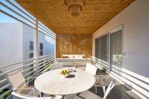 a room with a table and chairs on a balcony at Flamm Residences in Bodrum City
