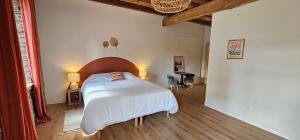 a bedroom with a large bed with a wooden headboard at Les Échappées Belles - Gîtes et chambres d'hôtes 4 étoiles in Antignac +128 photos